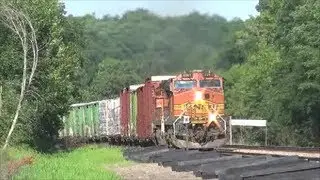 BNSF mixed freight train passes new ties on the side of the track