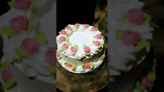 vanilla cake decorated with white frosting and pink and green icing flowers #ytshorts #2025 #cake