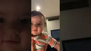 Cute baby eating camera