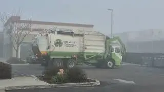 Mid Valley Disposal Front loader picking up gray trash dumpsters Sanger California