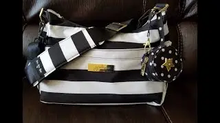 Jujube Hobobe in the First Lady print with seatbelt strap attached