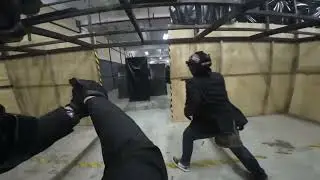 A group of idiots wearing suits to an airsoft game