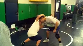 Coach Mike Barreras teaching wrestler 