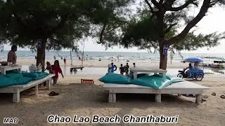 Eating Dried Squid on The Beach, Chao Lao Beach Chanthaburi Thailand.