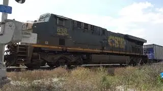 CSX mixed freight train with ambulance waiting to get by.  Locomotives 968, 2383, 6983 & DPU 838