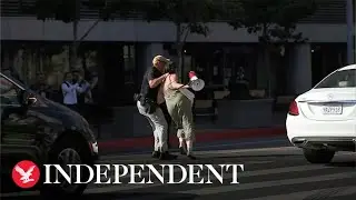 Protester tackled and restrained by police after shouting at Biden motorcade