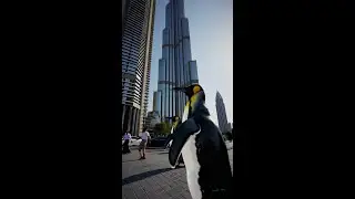 A penguin stands proudly on a bustling street in Dubai #Ai