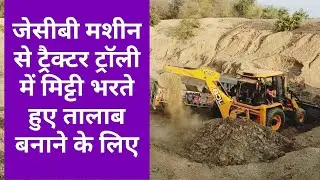 JCB machine fully loading mud in Tractor Trolley for making pond