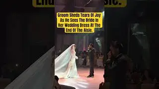 Groom Sheds Tears Of Joy As He Sees The Bride In Her Wedding Dress At The End Of The Aisle.
