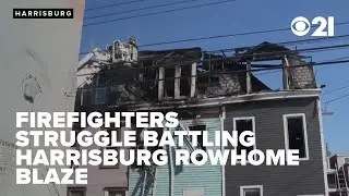 Salt truck brought in as firefighters struggle battling Harrisburg rowhome blaze