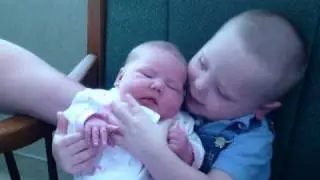 big brother holding babysister