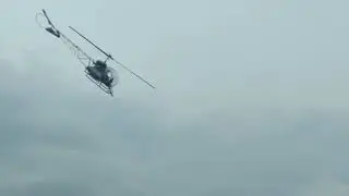 Helicopter spraying corn field