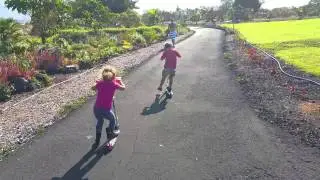 Maddy and Noah zip around on scooters