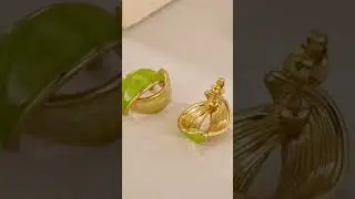 Sophisticated marbled gold and lime-green intertwined band earrings .