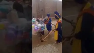 A Punjabi Sikh is breaking the valuables of a poor Bihari.