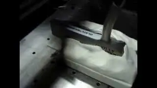 Laser engraving a golf putter.