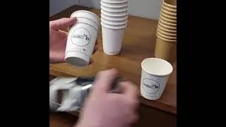 Printing coffee cups with a rubber stamp.