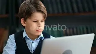 Confident Male Kid Pupil Chatting Typing e Learning Use Laptop Library Bookshelves Interior