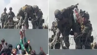 Afghanistan: Young baby passed over barbed wire fence to soldiers at airport