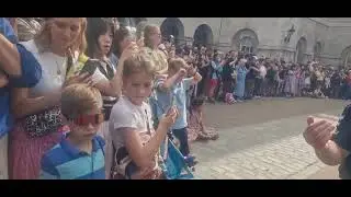 KIND POLICE OFFICER BRINGS KID IN A WHEELCHAIR FAWARD TO SEE 4 O CLOCK PUNISHMENT PARADE 
