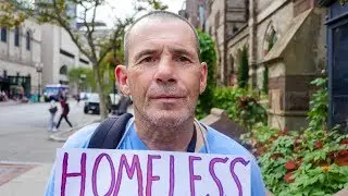 Homeless Man in Boston Flying a Sign That Reads 
