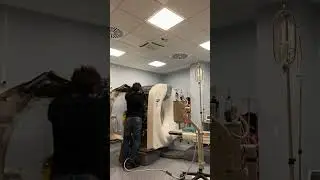 Dedicated Service Engineer Working Tirelessly to Fix a Complex CT Scanner
