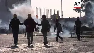 Protesters disperse after police move past barricades and fire tear gas