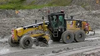 Motor Grader 14M3 Caterpillar Working On Wet Mine Roads