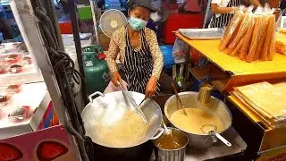 Thai Street Food: a lady cooking Khanom LA