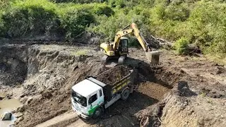 ExcavatorCAT313C digging and loading soil fast and clean. Real construction site footage.