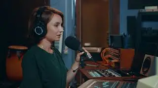A Female Audio Engineer In Control Of A Recording Studio