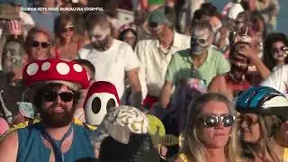 'Zombies' ride bikes down Key West shoreline during Halloween festival