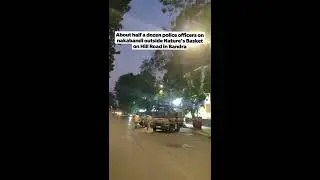 About half a dozen police officers on nakabandi outside Nature's Basket on Hill Road in Bandra