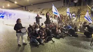 Anti-government protesters block roads and scuffle with Israeli security forces in Tel Aviv