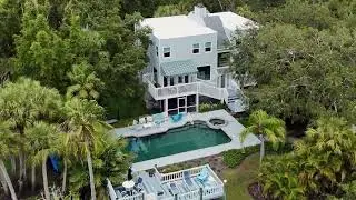 Serene Waterfront Estate on 2385 Fiesta Drive | Private Dock & Lush Landscaping in Sarasota