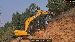 JCB Excavater pushing sloppy hill- Jcb backhoe cleaning dirt in hill new road constraction