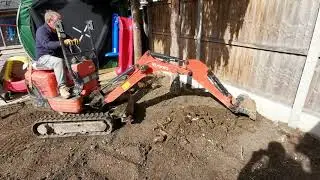 Digging out a tree stump with my mini garden digger