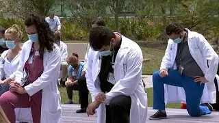 Nemours Children’s Hospital staff kneel in silence in support of ‘White Coats 4 Black Lives’ mov...