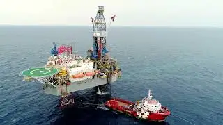 VideoVault Stock Video: Offshore oil rig in operation drone view