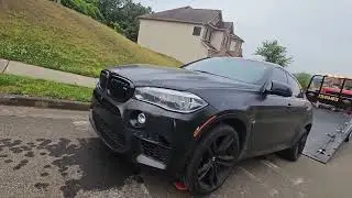 Bmw X6 M series loading on a  rollback flatbed towtruck using skates, I drop the keys in the drain!!