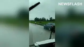 Bizzare Accident Leads To Car Flipping Over Guard Rail And Landing Perfectly On Top Of A Bus Stop