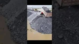 Filling the lake to create land and the bulldozer laid the roadbed