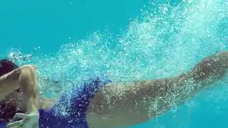 stock footage brunette woman swimming underwater in slow motion