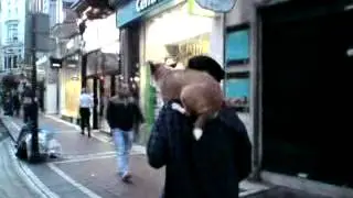 Man Carries a Dog On His Shoulder