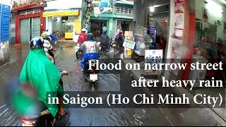 Flood on narrow street after heavy rain in Saigon (Ho Chi Minh City, Vietnam)