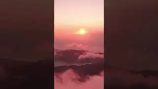 Airplane view of a sunrise above the clouds #shorts #clouds #travel