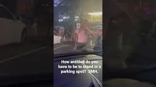 Woman tries to stand in a parking spot to save it for her boyfriend.