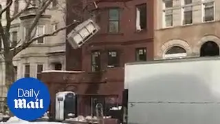 Clearing house! Couch goes sailing through window and into street - Daily Mail
