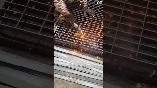 Cutting metal grating with sparks from plasma tool.
