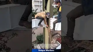 Steel beam installation: steelworkers installing a steel beam